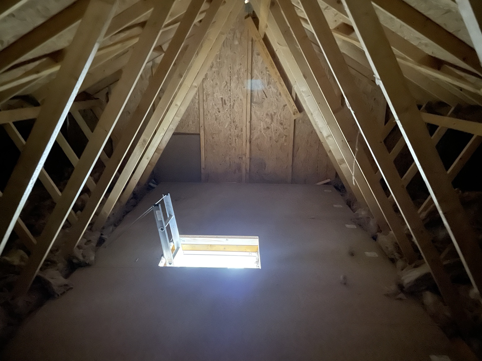 Raised loft boarding installed around roof trusses